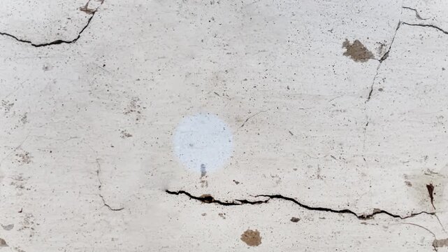 Seamless 4K looping vertical movement across a white plaster wall with a long horizontal crack and aged texture. Great for minimalist architectural backgrounds and motion design.