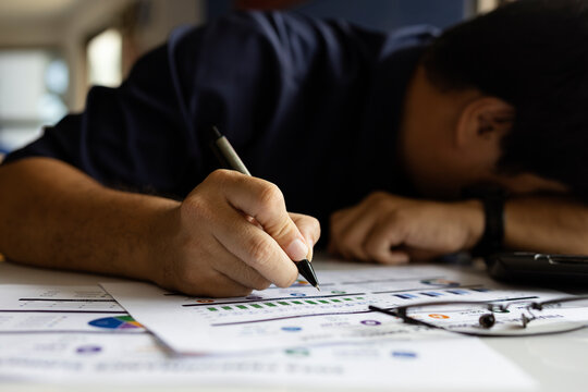 Exhausted worker writing reports with 24 hour clock and communication icons