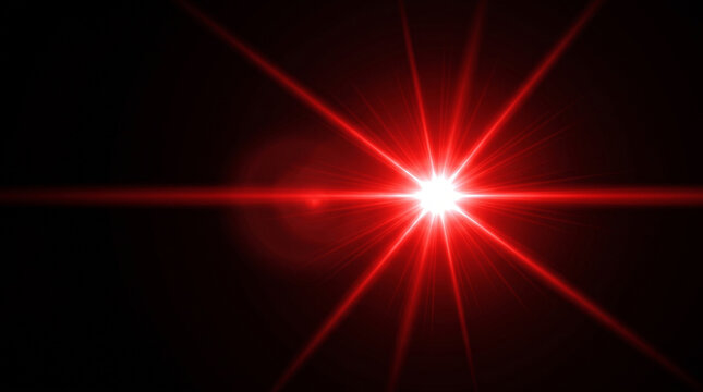 Bright red starburst light effect with lens flare isolated on a solid black background for design