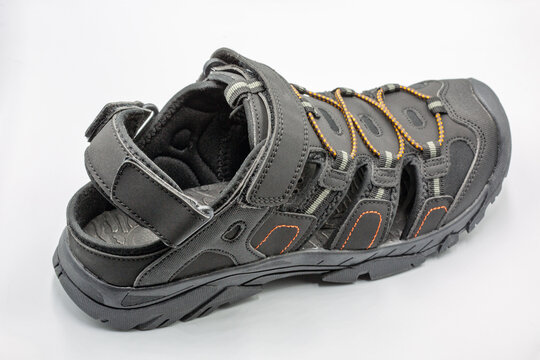 Mens black sporty trekking sandals active footwear closeup on white.