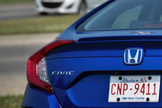 Calgary, AB, Canada. August 16, 2026. Close-up rear angle of a blue Honda Civic showing logo emblem, tail light, and license plate.