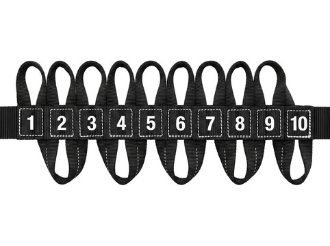 Yoga stretch strap numbered loops fitness belt for physical therapy workout flexibility training isolated on black background accessory equipment for pilates gymnastics exercise home gym routines.