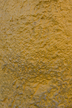 Yellow ocher rough textured stucco wall background