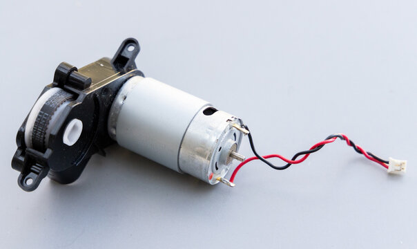Small DC Geared Motor with Wires and Timing Belt on Grey