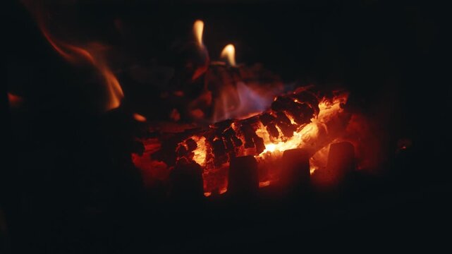 Slow Motion Close-Up of Burning Charcoal with Flaking Char