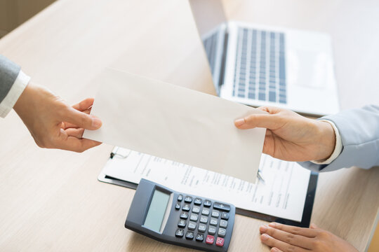 Good job, asian manager business giving financial reward in an envelope, business letter extra salary to company employee, woman worker office hand received premium bonus, getting cheque from her boss