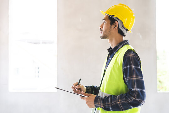 Building inspection asian contractor young man, male inspecting home, reconstructed construction, renovation or check defect, before finish handing it over to client, customer. Engineering worker.