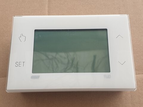 White Digital Thermostat with Blank Screen and Control Buttons