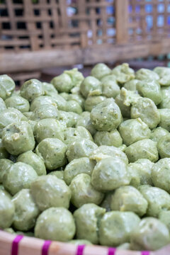 Green bakso aci tapioca based meatballs that resemble fish balls, meatball style dumplings, or traditional snacks like mung bean cakes or cilok. 