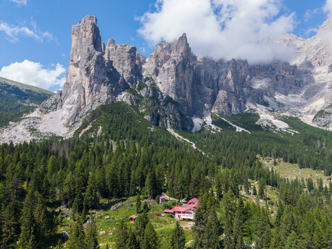 Taibon Agordino, Veneto, Italy - 17 August 2026: Aerial view of Rifugio Mario Vazzoler nestled in the Civetta massif, surrounded by dense coniferous forests and dramatic limestone peaks.