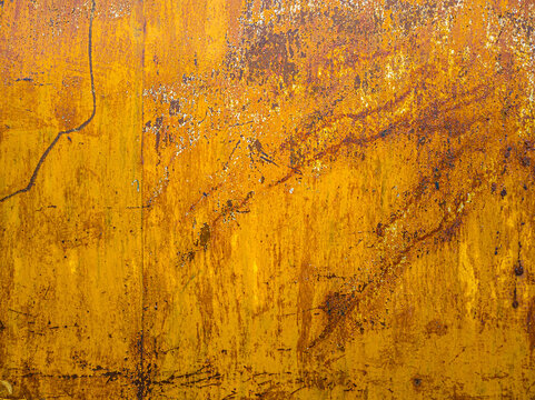 Weathered Yellow Metal Surface with Rust and Peeling Paint