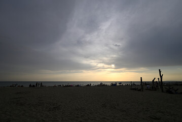 Obraz premium Torre del Lago, Tuscany, Italy - August 12th 2026 - People at the beach looking at the partial solar eclipse.