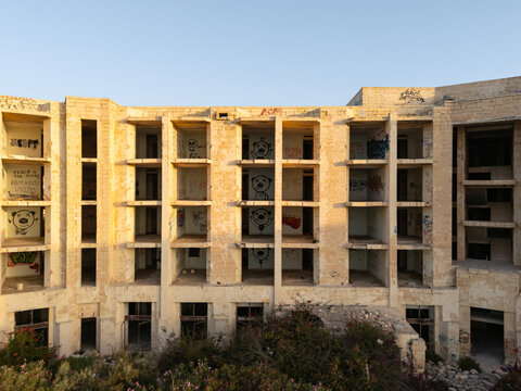 Aerial view of abandoned Jerma Palace ruins on the Malta coast at sunrise