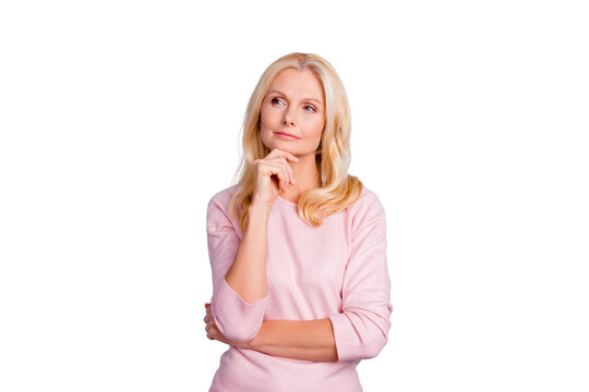 Portrait of cunning curious emotion expressing pretty charming candid with long wavy curly haircut pensive granny planning weekend vacation holiday wearing casual pullover isolated on gray background