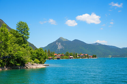 village and lake Walchensee, bavarian tourist resort in summer. Jochberg mountain behind