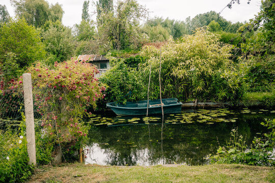 Boat on a Calm Water Beside Greenery in a Quiet Area