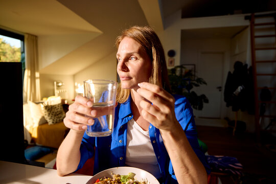 Woman grabs the medicine before eating