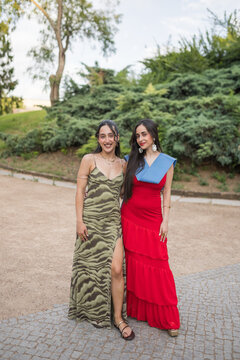 Two Young Women Celebrating Graduation in a Park Outdoors