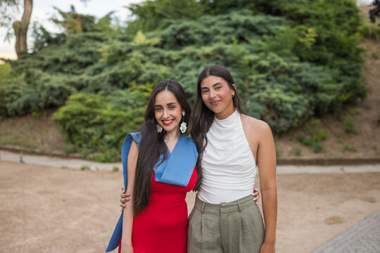 Portrait of Two Smiling Young Women at Graduation Event