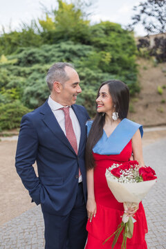 Happy Father Posing with Graduated Daughter at Ceremony