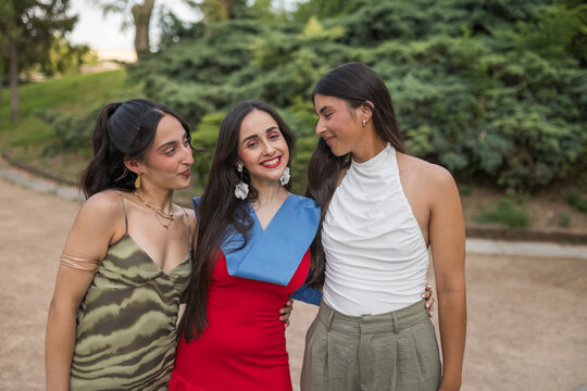 Group Portrait of Three Young Women at Graduation Event