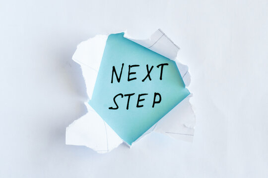 Next Step Handwritten Message Revealed Through Torn Paper, Planning, Progress and Process Concept