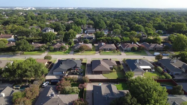 Contrasting charcoal, brown rooftops line Lost Creek properties across DFW suburbs. Blooming crepe myrtles, detached car garages accentuate classic family homes, Coppell, Texas