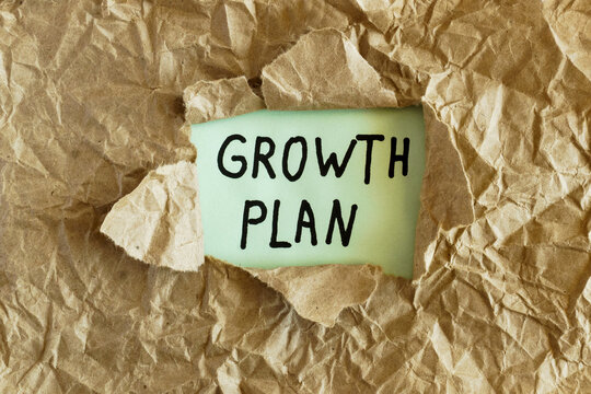 Growth Plan Handwritten Message Under Torn Kraft Paper, Business Strategy and Expansion Planning Concept