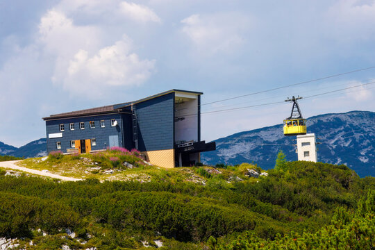 Dachstein Krippenstein, iconic bright yellow cable car cabins and gondolas that transport visitors up the mountain slopes in Obertraun, Austria.