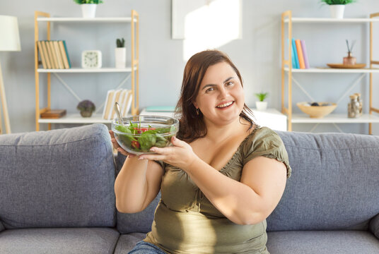 Happy slimming vegetarian diet, eating green vegetables, veggies salad menu for dinner, pleasant obese woman at home, chubby overweight plus size big fat fit lady weight loss, healthy, balanced diet