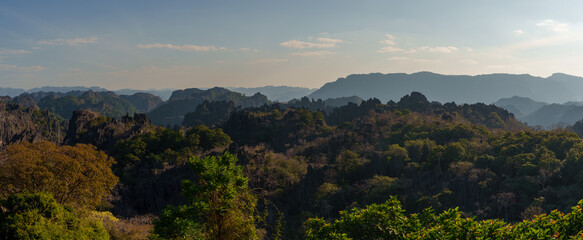 Fototapeta premium Panoramic Karst Mountains and Forest Beneath Blue Sky
