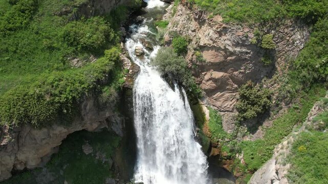 Top-down aerial view of Trchkan waterfall plunging into a rocky pool, Armenia