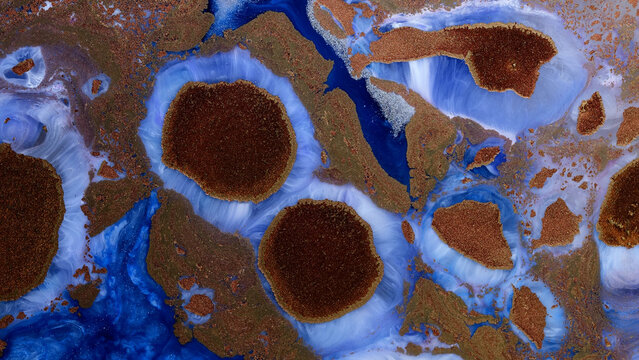 Mixing different colored alcohol inks and epoxy resin in close-up view