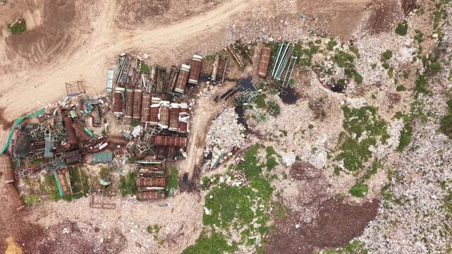 Used filtration units stacked beside a waste segregation yard from above