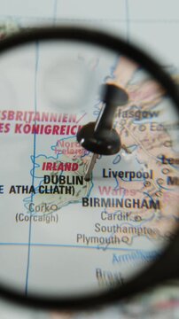 Exploring a printed map with a magnifying glass over the location