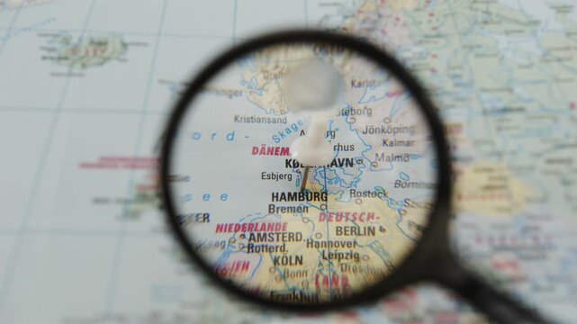 Exploring Hamburg through a magnifying glass on a printed map