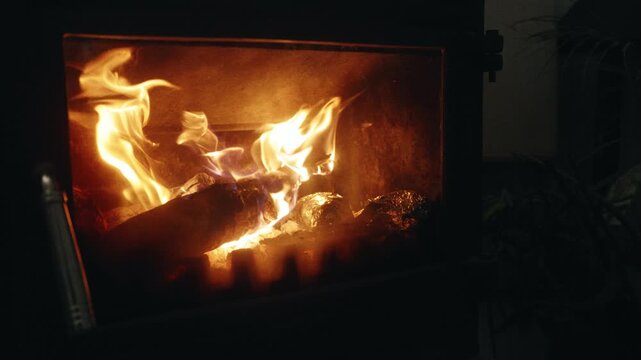 Slow Motion Locked-Off Shot of Burning Firewood in a Stove