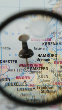 Pinpointing a location on a paper map using a magnifying glass