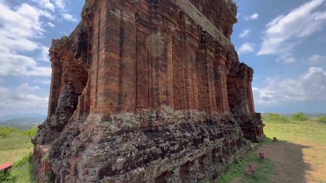POV walking shot approaching ancient Banh It Cham south tower, examining brick carvings and entering inside in Quy Nhon, Vietnam