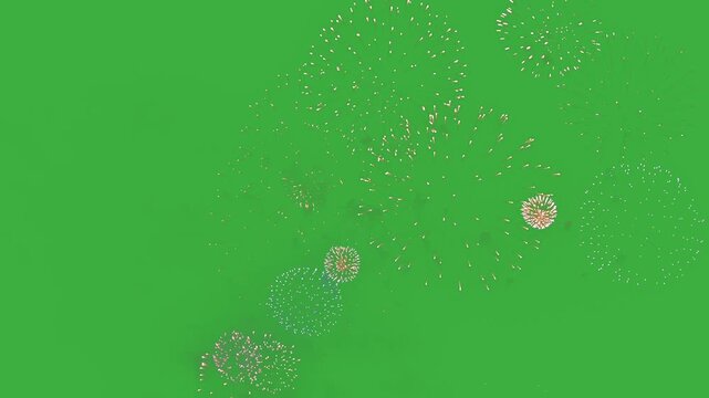 Isolated fireworks burst on green screen for chroma key use