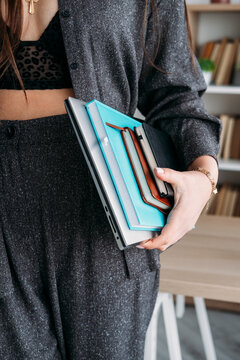 Professional workflow. Office worker. Unrecognizable business woman with laptop notebook for career routine at modern workspace.
