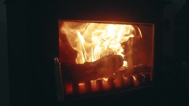 Slow Motion Close-Up of Burning Firewood Flames in a Fireplace Stove