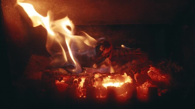 Close-Up Slow Motion of Burning Firewood and Flickering Flames in a