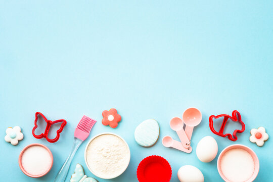 Easter baking background at blue flat lay.