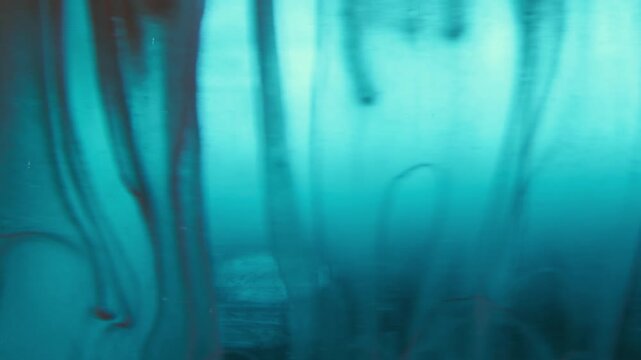 Paint drop. Color smoke. Defocused blue neon water splash creative flow smog drip vapor texture spilling on abstract background.