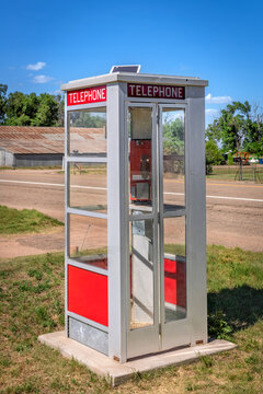 Old telephone booth on a corner of an abandoned town