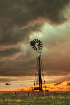 Rustic old farming windmill in stormy weather