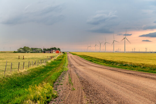 Dirt road winding through a beautiful windfarm