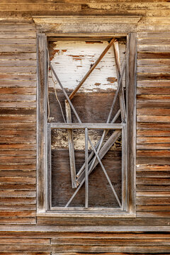 Boarded up old window on an abandoned home