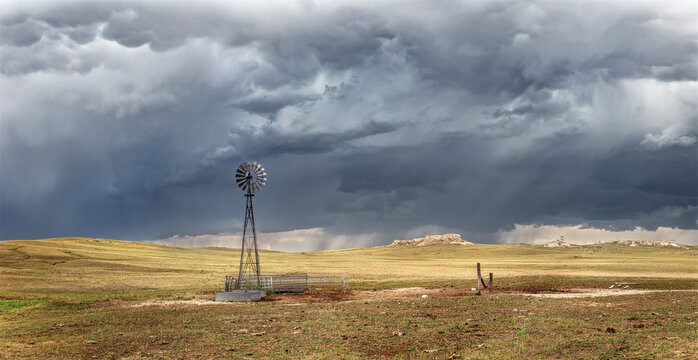 Rustic old farming windmill in stormy weather